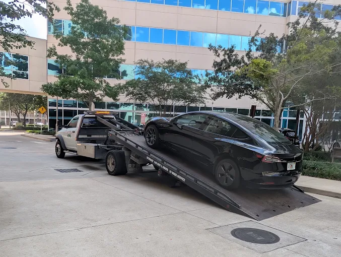 Katy Towing flatbed truck loading a Tesla in the greater Houston area